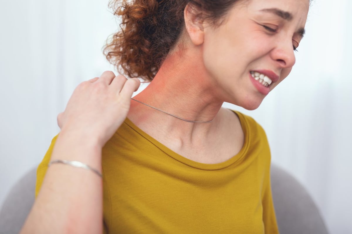 Junge Frau reagiert allergisch auf Kette. Schmuck mit Nickel kann Kontaktekzeme auslösen.