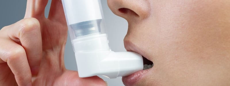 Frau verwendet Asthma-Spray mit Inhalator.