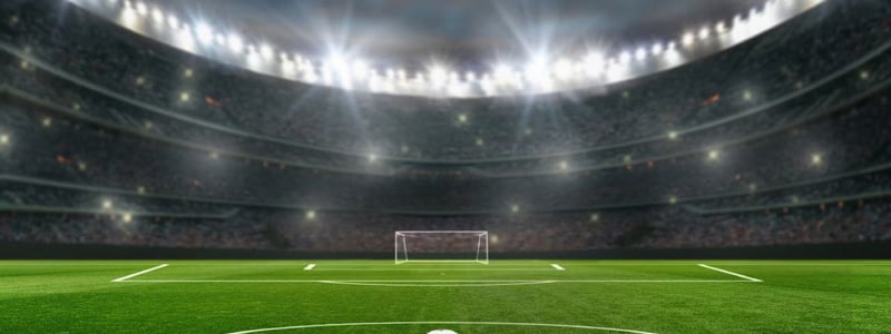 Fussball liegt im Stadion vor der Mittellinie. Im Hintergrund Flutlicht und ein leeres Tor.